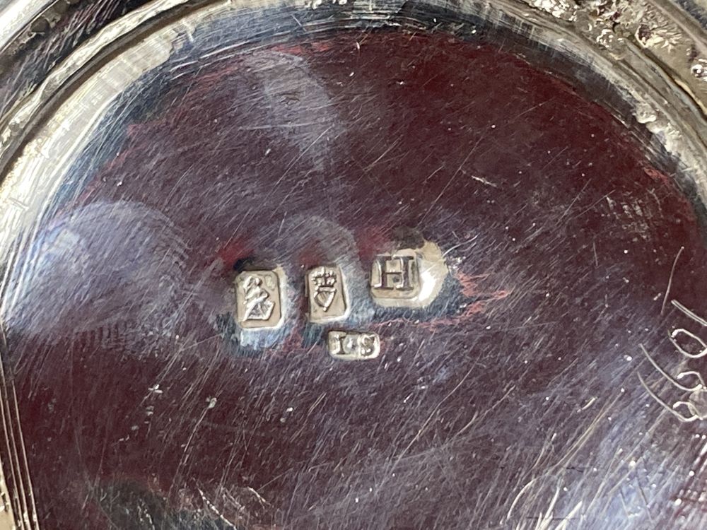 A George III Irish embossed silver bachelors teapot, James Scott, Dublin, 1804, on an associated Irish silver circular stand, 9oz.